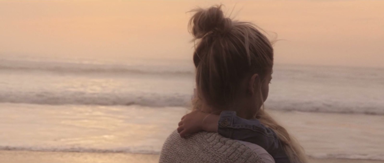 Kate holding her daughter Annabelle on the beach
