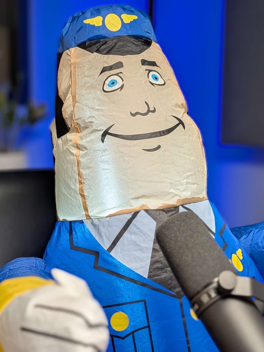 Otto, the studio's inflatable autopilot, at the podcast mic