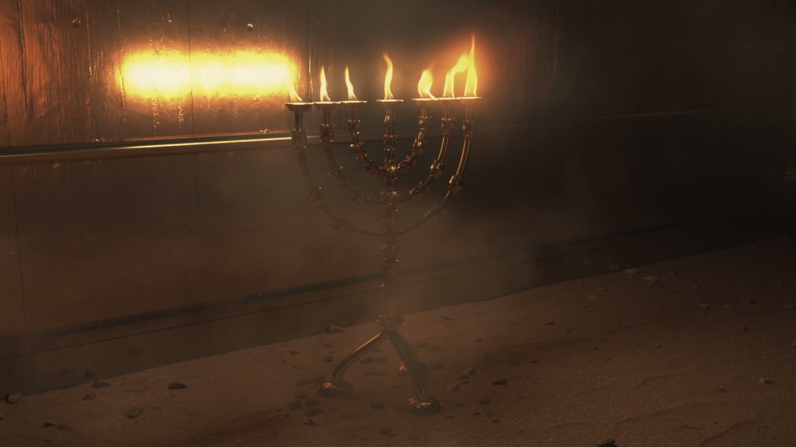 The golden Menorah, lamps lit, in the Holy Place